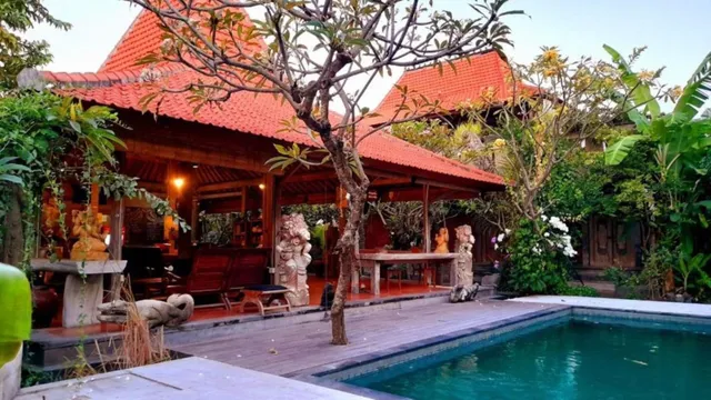 Peaceful pool and traditional Balinese pavilion at Bali Telaga Hati